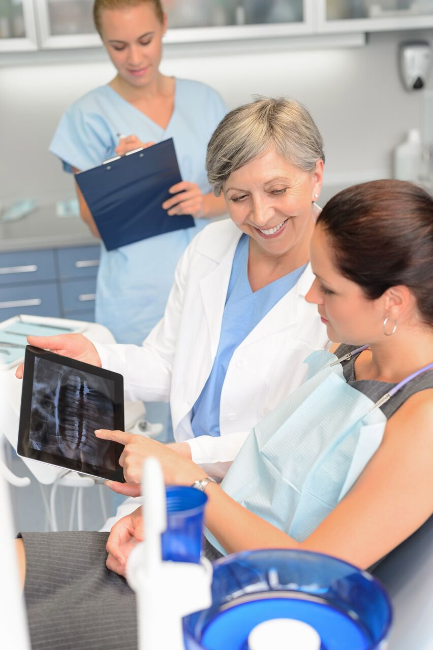 A dentist showing the results to the patient - Mississauga Dentist - Bristol Dental